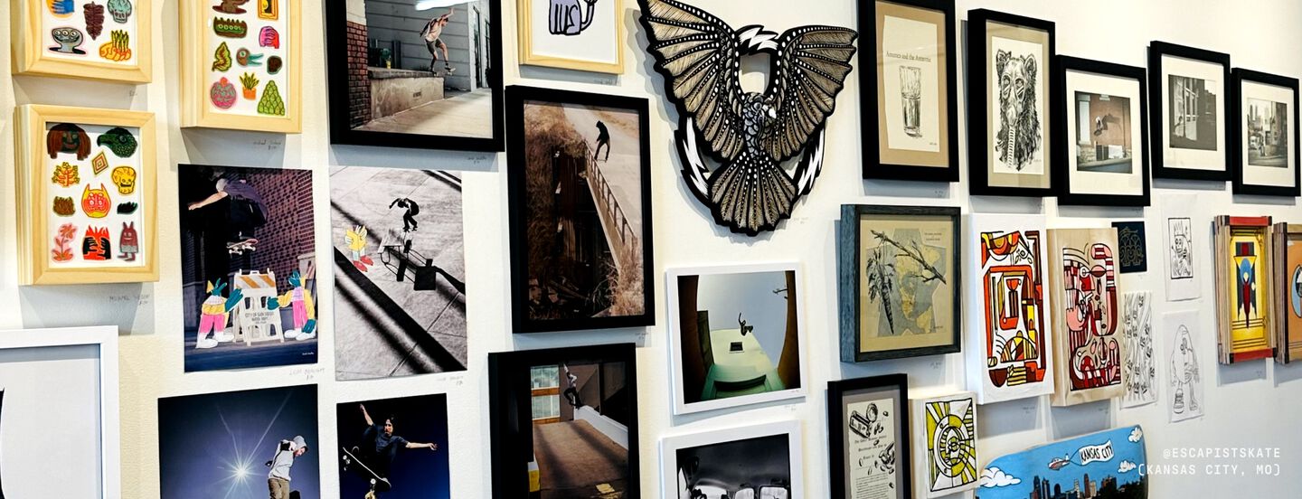 Photo of a gallery wall of pictures hanging on a wall in a skate shop.