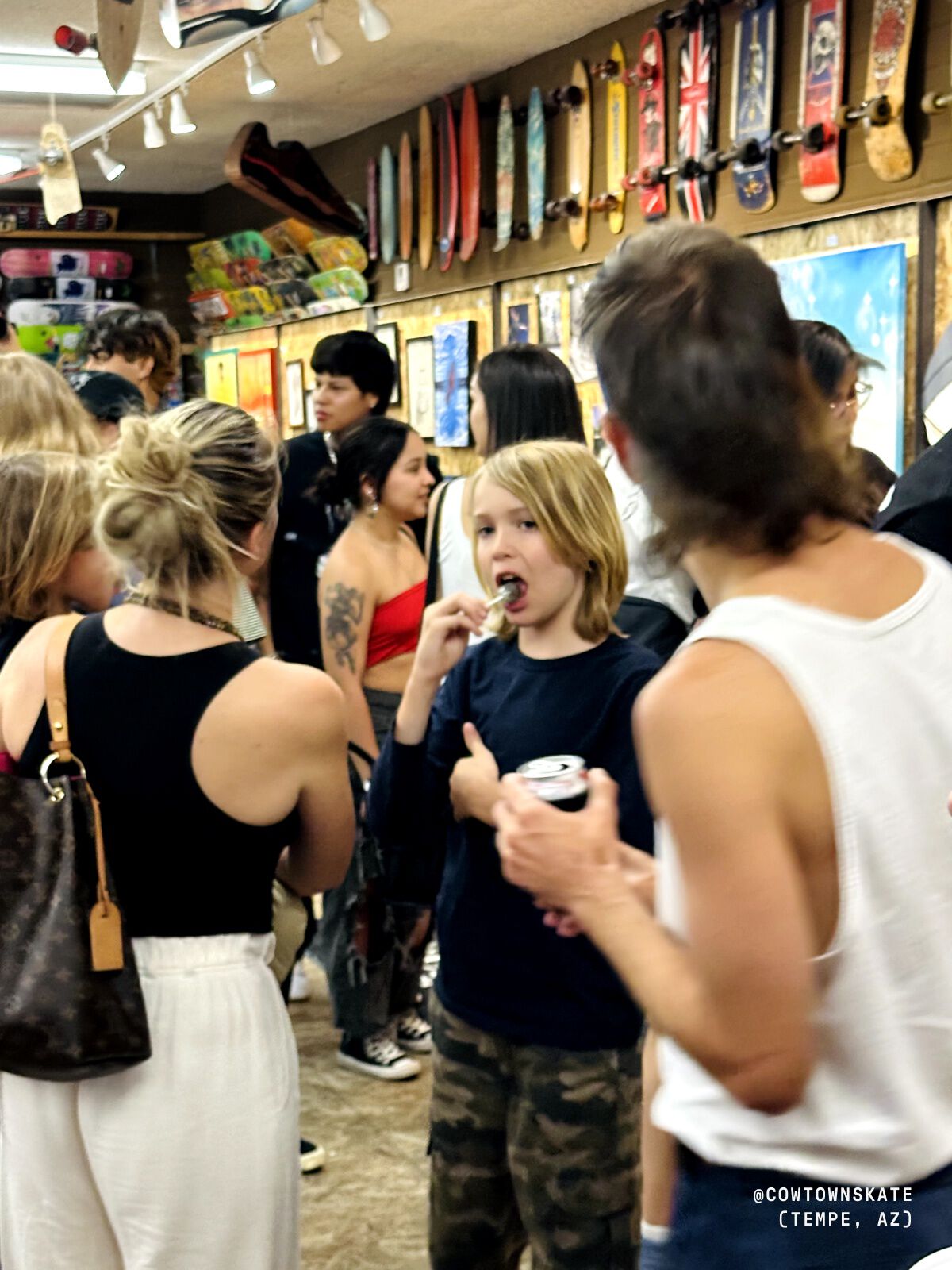 Photo of people standing inside the skate shop.